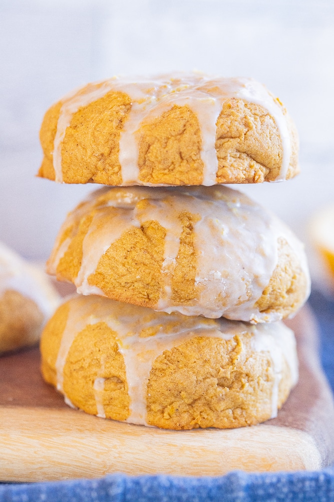 close up of three soft pumpkin cookies stacked on top of each other