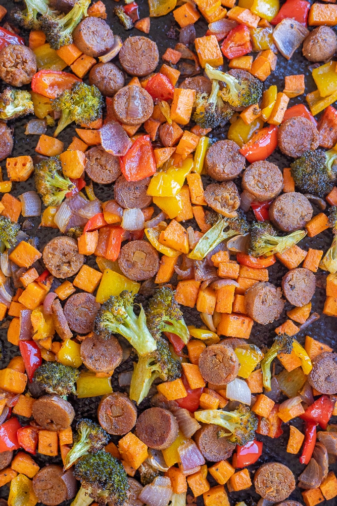 close up of sheet pan roasted peppers and sausage with broccoli