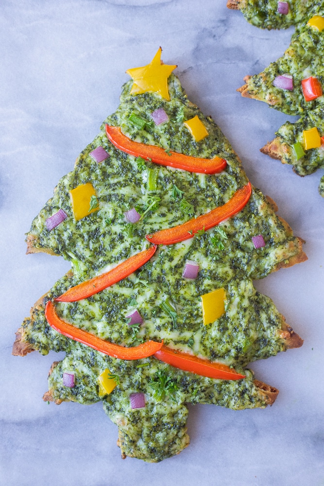 cheesy christmas tree naan pesto pizza with a red pepper garland