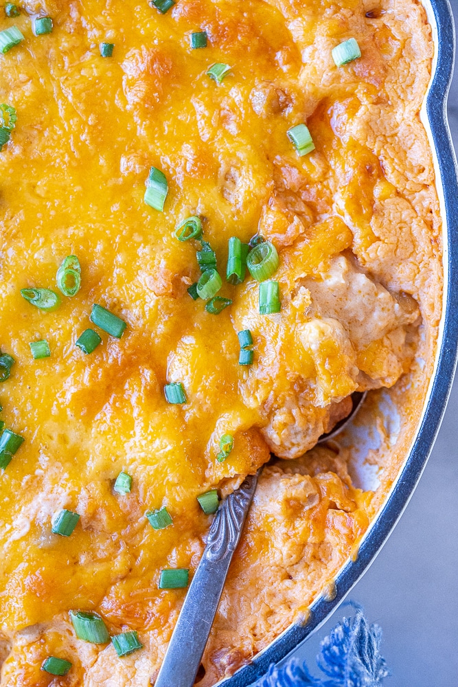 close up of a spoonful of buffalo chickpea dip in a pan
