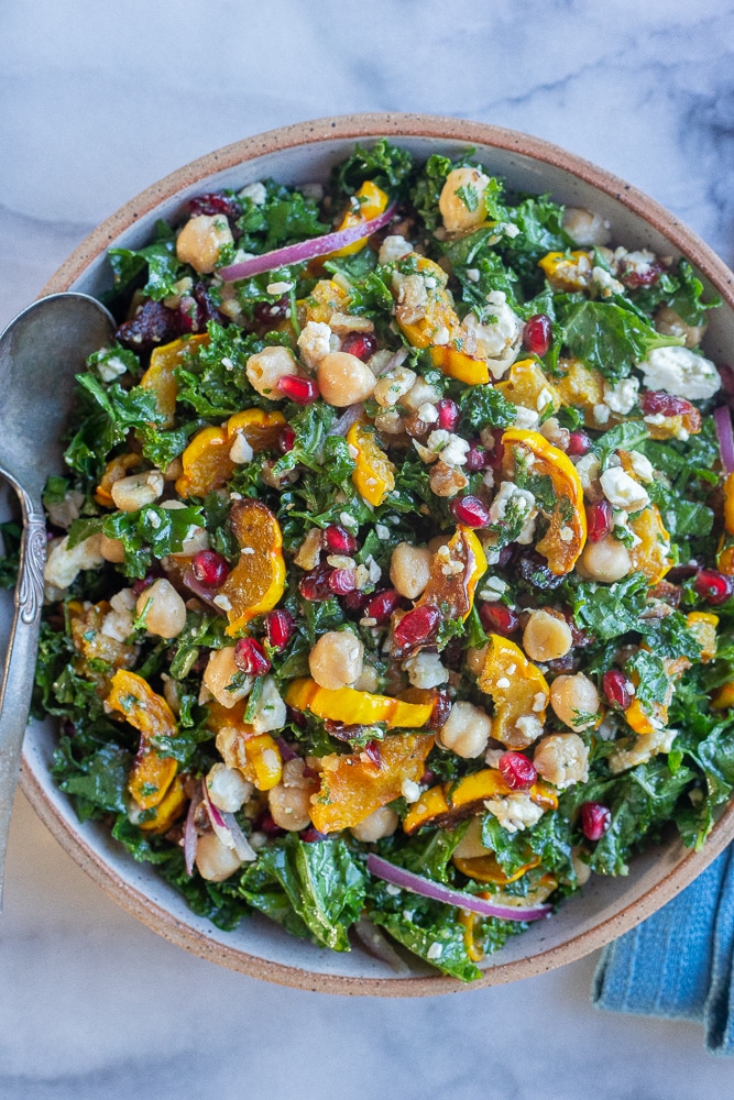large bowl full of roasted delicata squash salad with kale and chickpeas