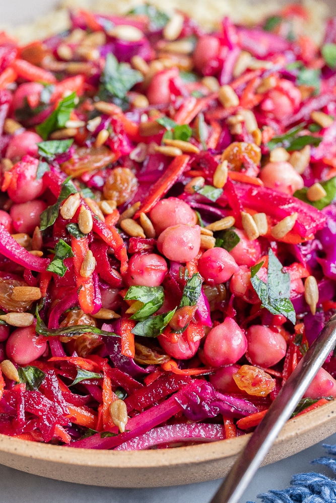 close up of a beautiful beet salad with carrots, cabbage and chickpeas