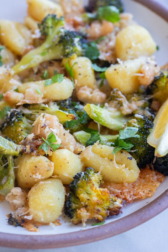 close up of sheet pan gnocchi and broccoli with white beans and parmesan