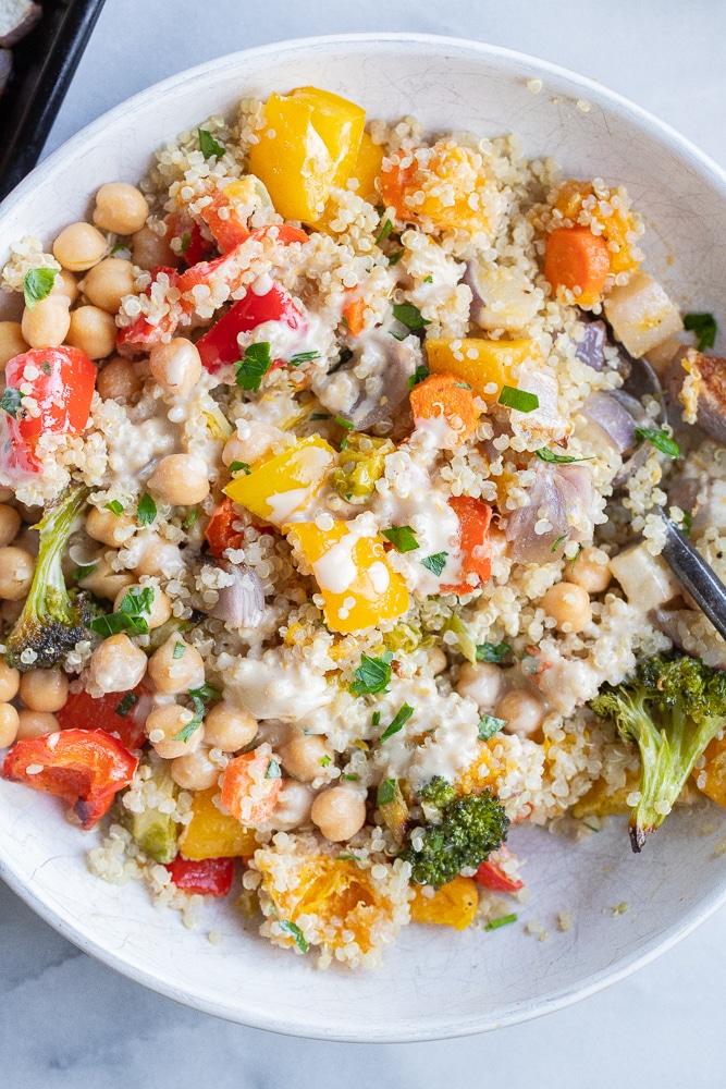 roasted vegetable buddha bowls all mixed together with citrus tahini dressing