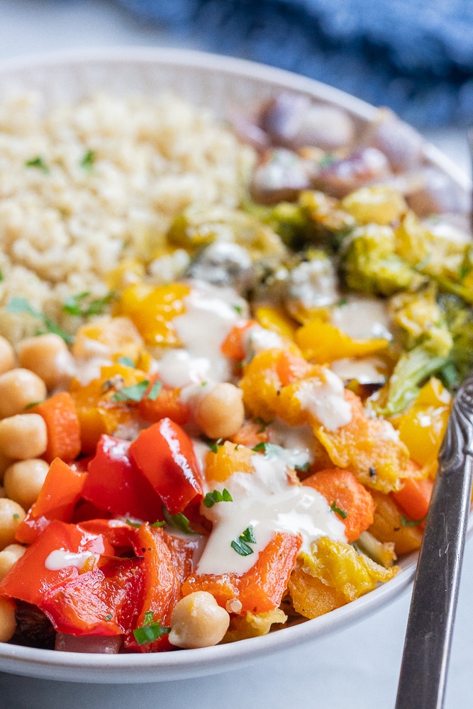 close up of rainbow buddha bowls with tahini dressing