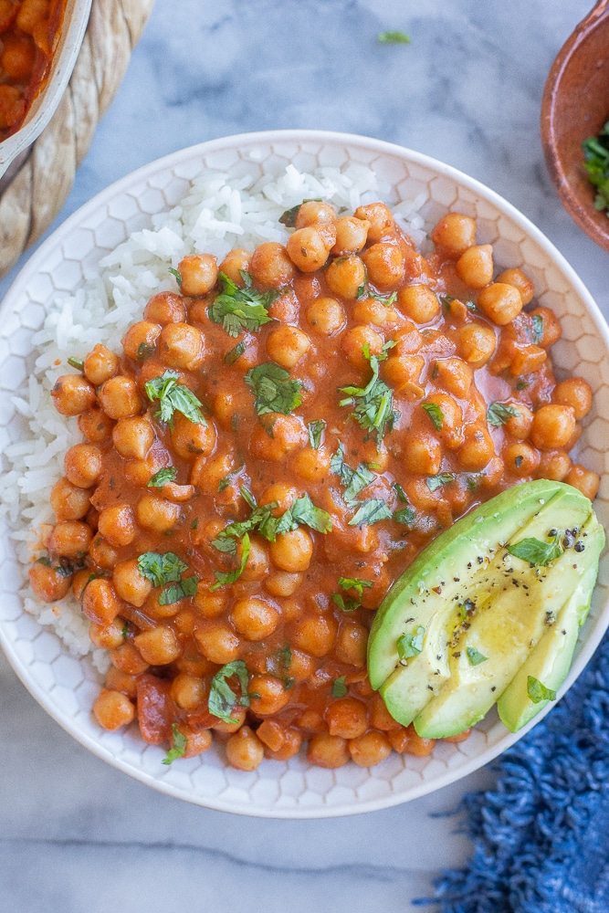 bowl of smoky coconut chickpeas with rice and a sliced avocado