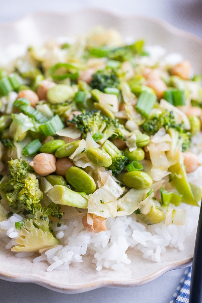 close up of an edamame and broccoli stir fry over rice