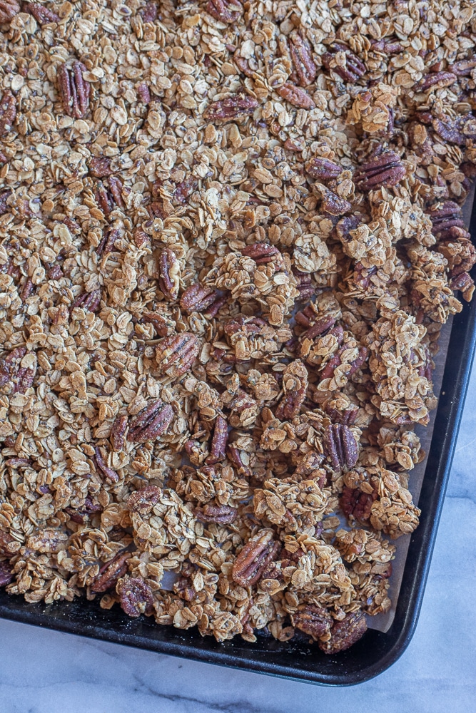 large clusters of maple pecan granola on a sheet pan