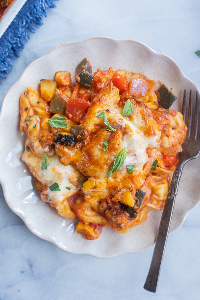 plate of cheesy tortellini casserole with roasted vegetables