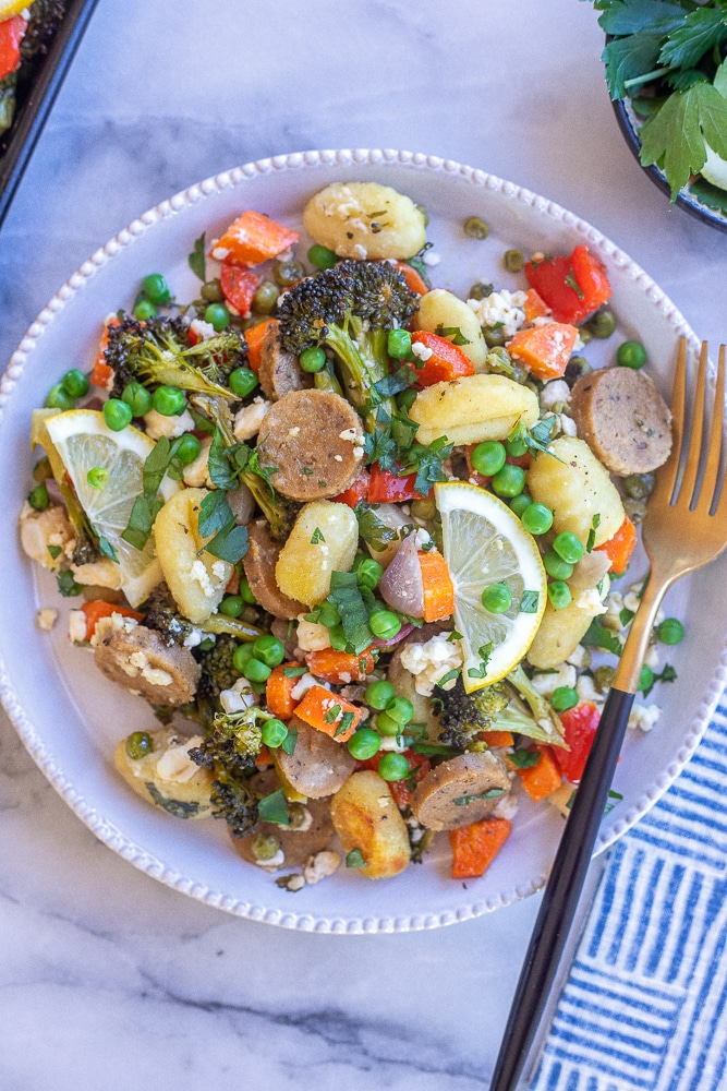 dinner plate with vegetarian and gluten free gnocchi sheet pan meal with veggies and sausage