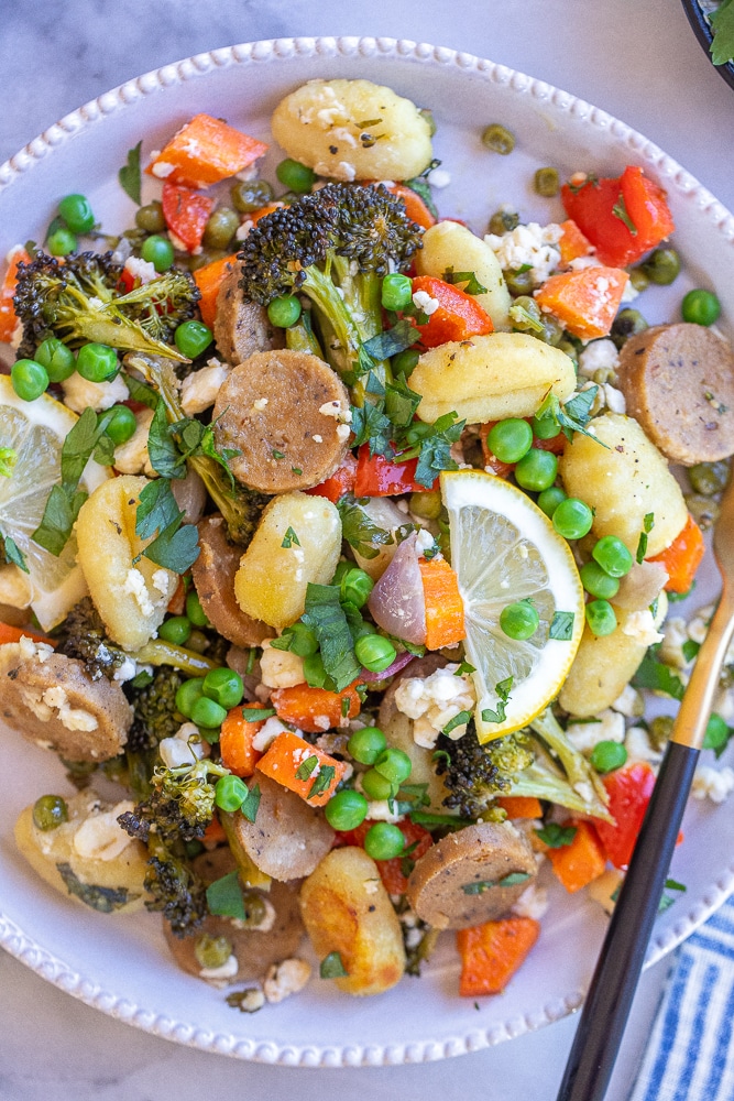 plate of roasted vegetable gnocchi and sausage bake with lemons