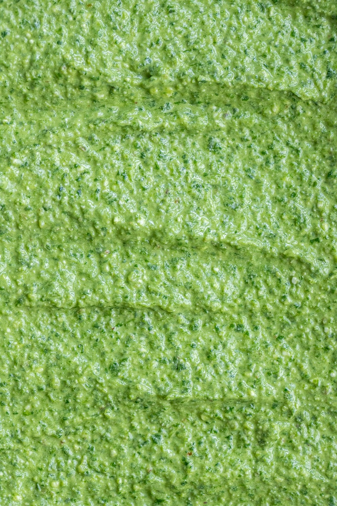 close up of homemade basil pesto with spinach and feta cheese