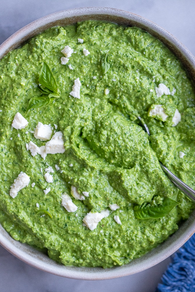 creamy homemade spinach and feta pesto sauce in a bowl