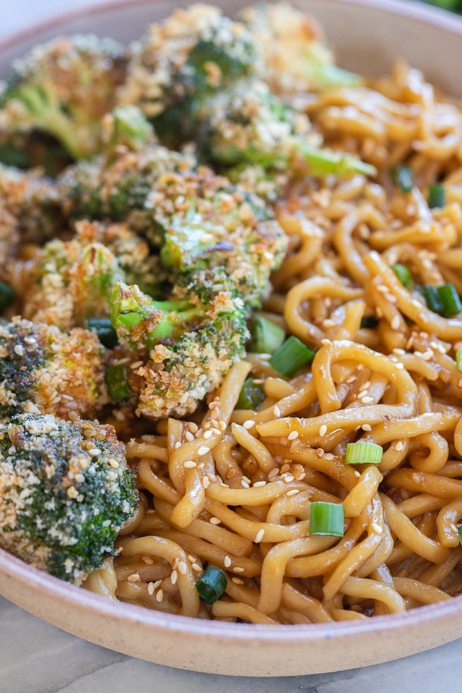 close up of saucy teriyaki noodles with crispy broccoli