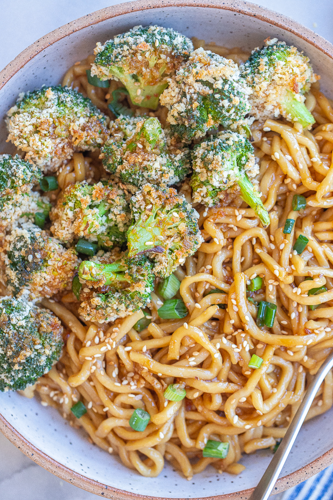 close up of crispy baked broccoli with teriyaki noodles in a bowl
