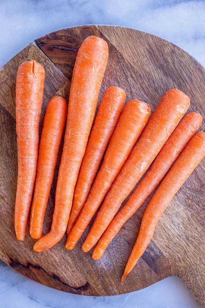 cutting board filled with orange carrots
