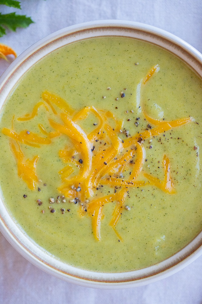 cozy bowl of zucchini cheddar soup with black pepper