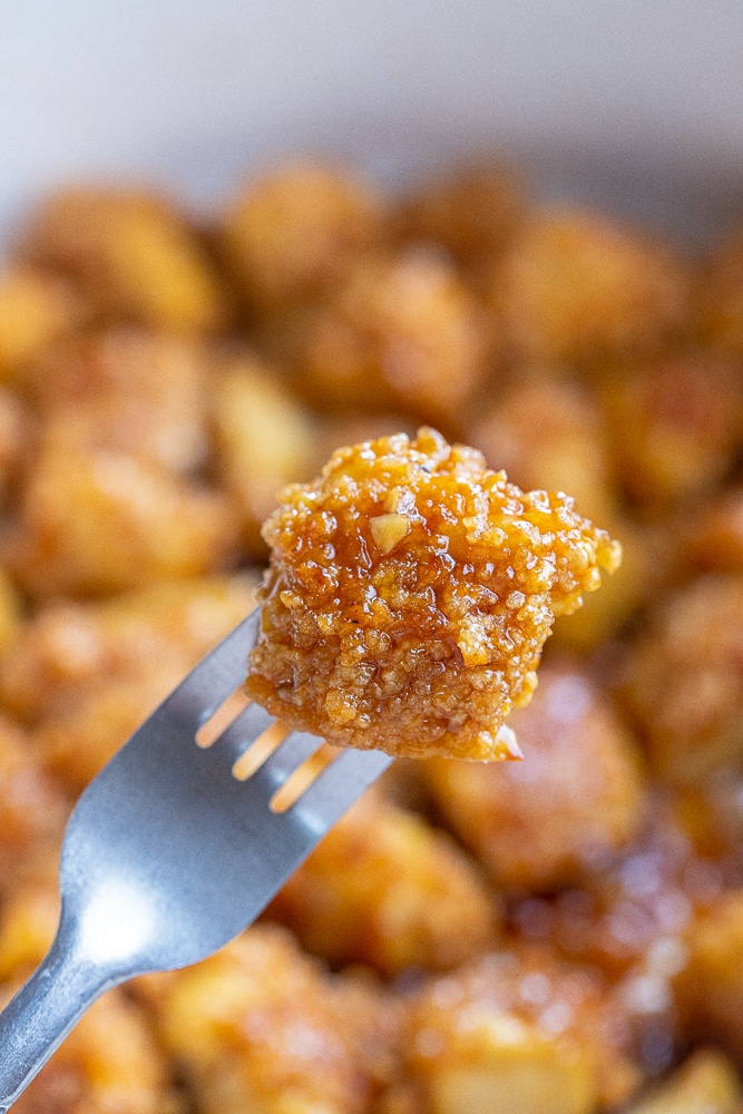 close up of a piece of crispy tofu on a fork