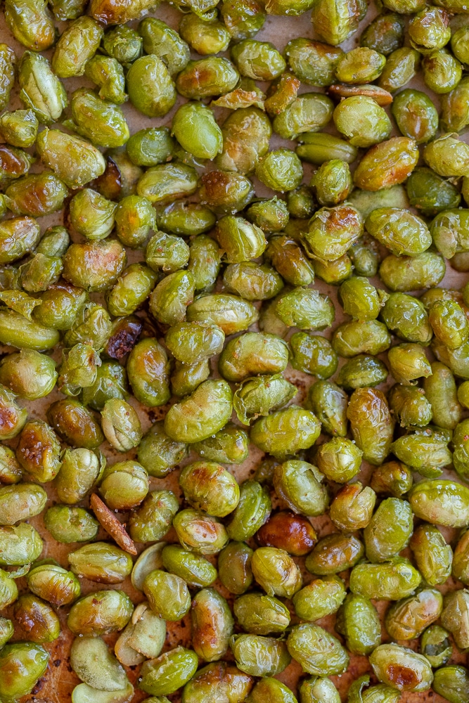 close up of salty roasted edamame on a sheet pan