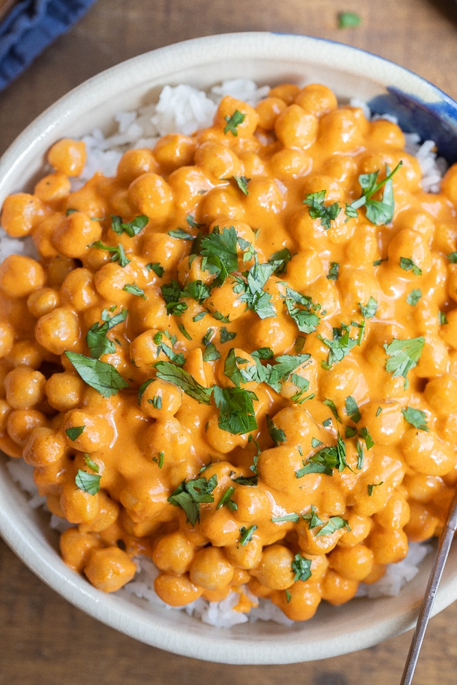 close up of a bowl of red curry chickpeas