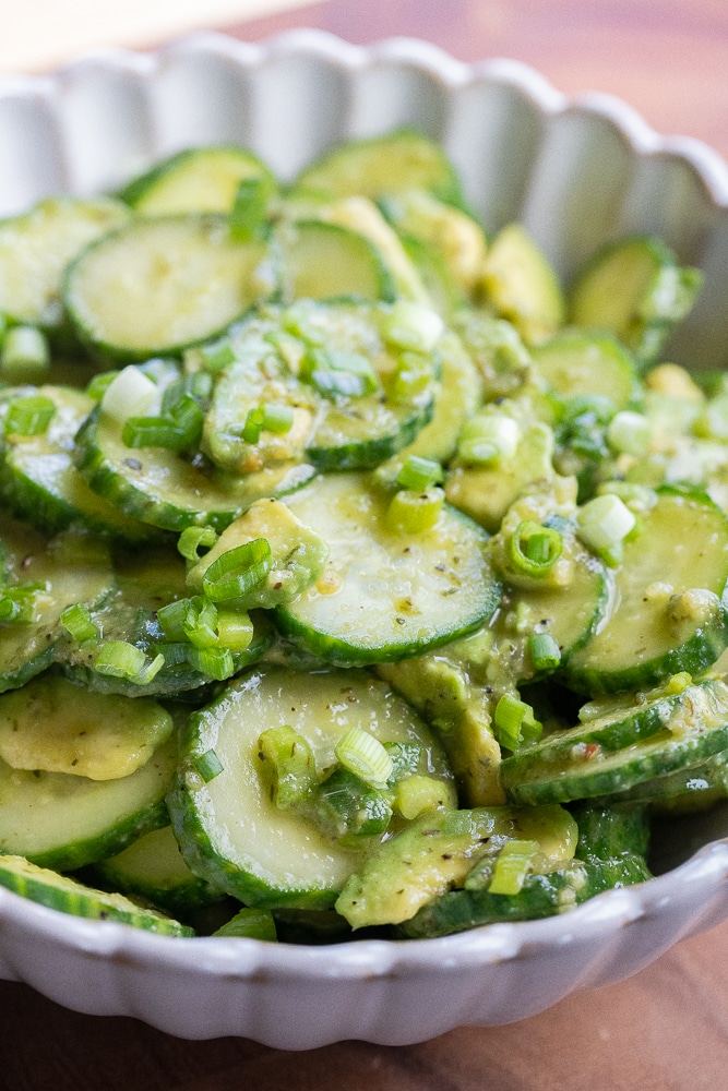 close up of a bowl of avocado cucumber salad