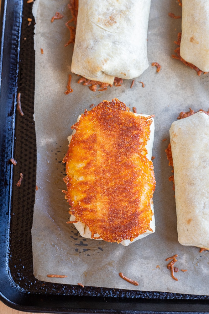bean and rice burritos baked in the oven with crispy cheese on the bottom