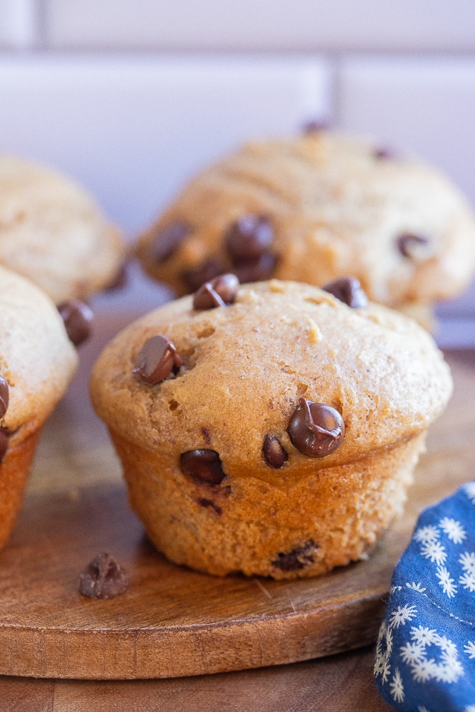 close up of a healthy chocolate chip muffin on a cutting board