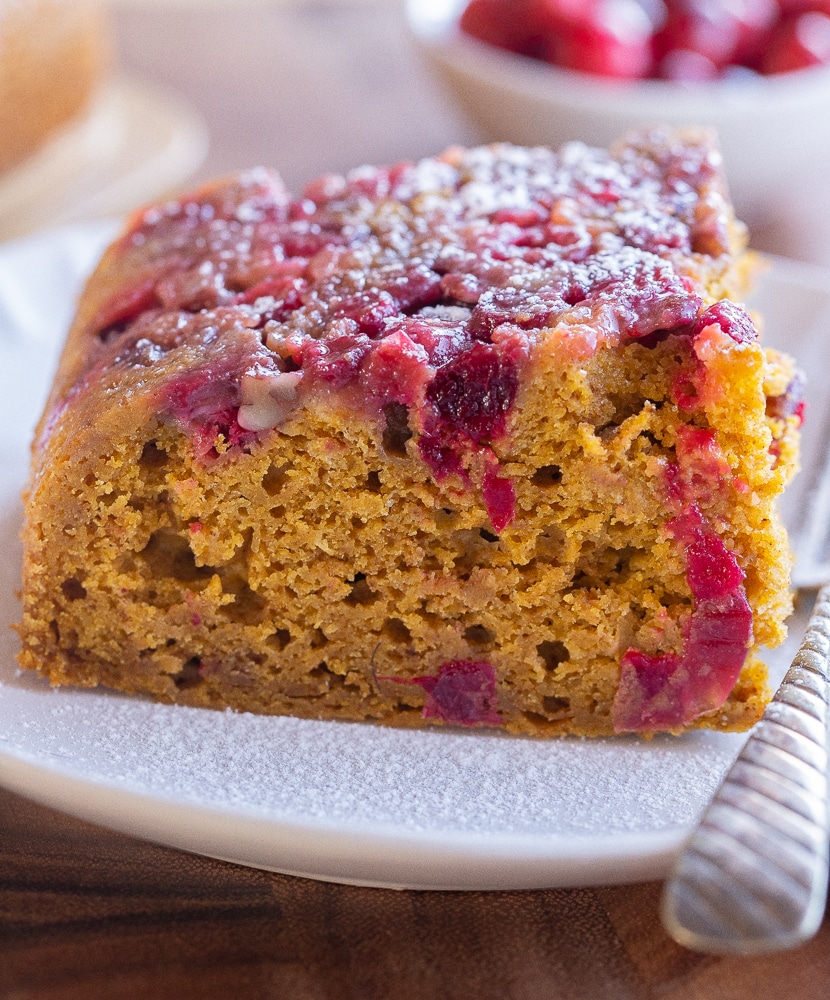 close up of cranberry upside down pumpkin cake on a plate