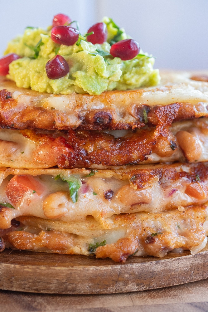 Close up of a stack of vegetarian black eyed pea quesadillas
