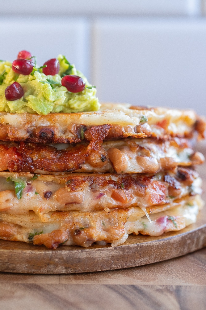 stack of black eyed pea quesadlilas on a cutting board