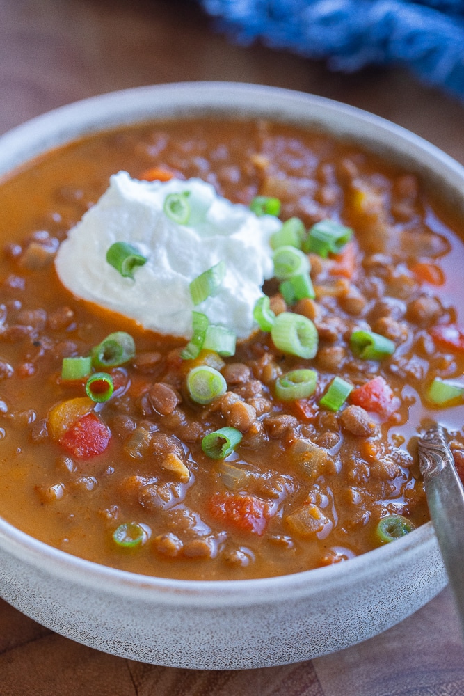 close up of a bowl of lentil chili topped with greek yogurt