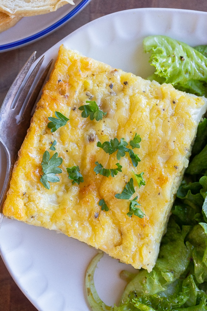 Close up of Cauliflower leek egg bake on a plate with salad