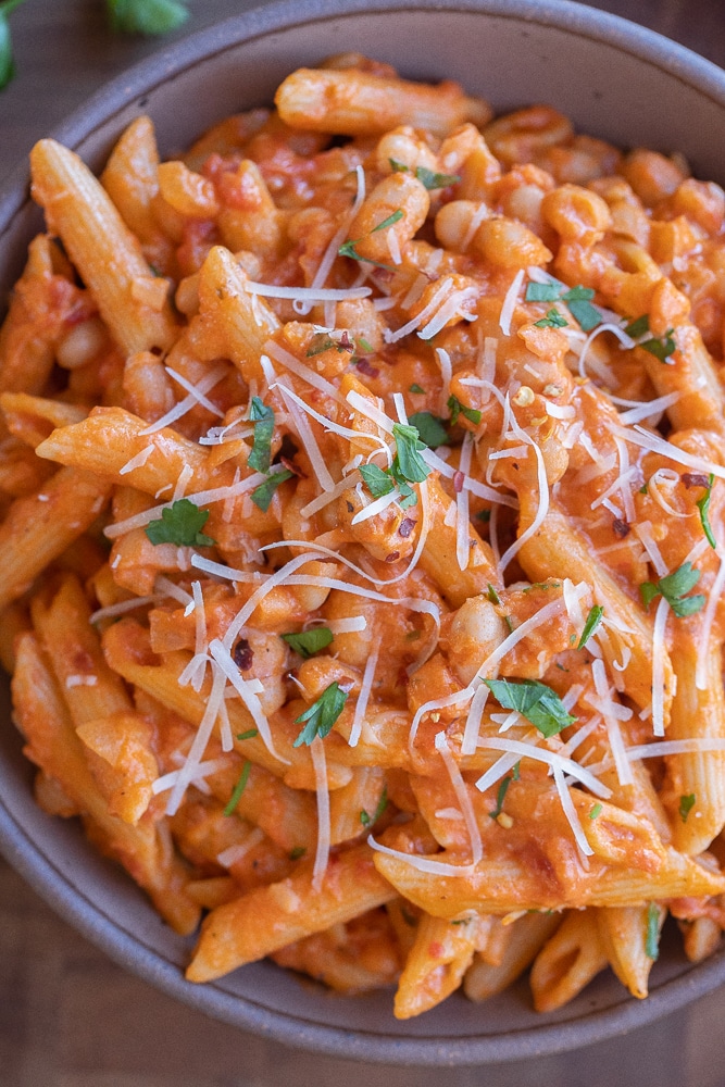 close up of a bowl of pasta with white beans