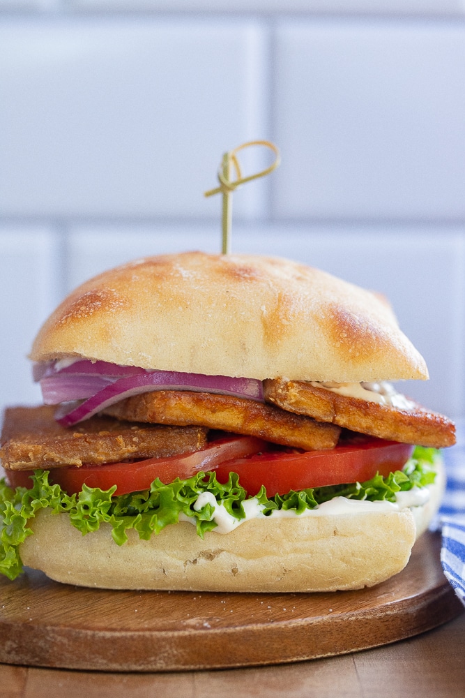 vegetarian BLT on a cutting board with a toothpick