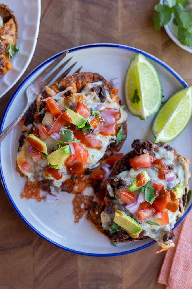 Black bean roasted sweet potatoes on a plate with toppings