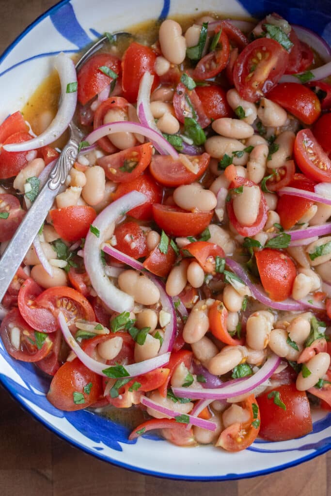 close up of a bowl of cherry tomato and white bean salad