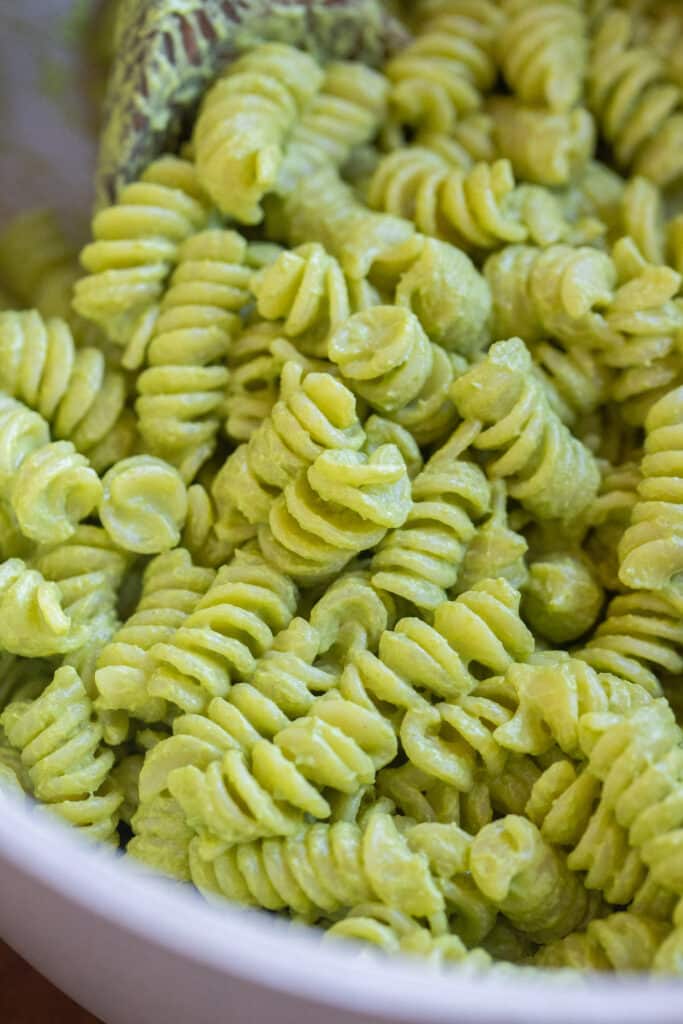 Close up of a pot of creamy pesto pasta