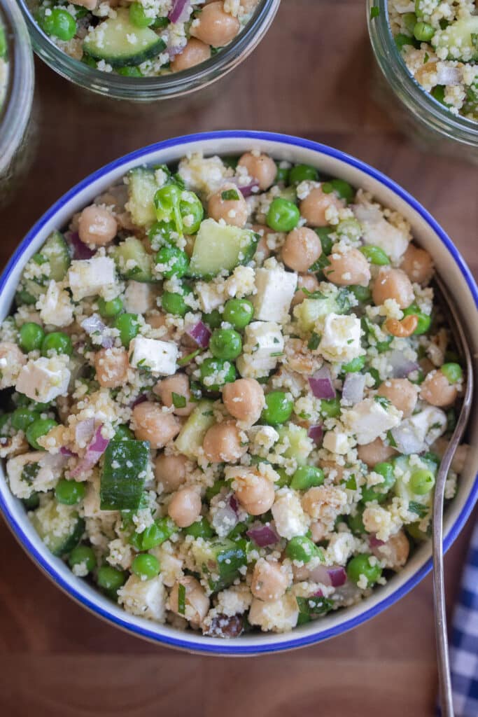 Close up of a bowl of protein packed sweet pea couscous salad