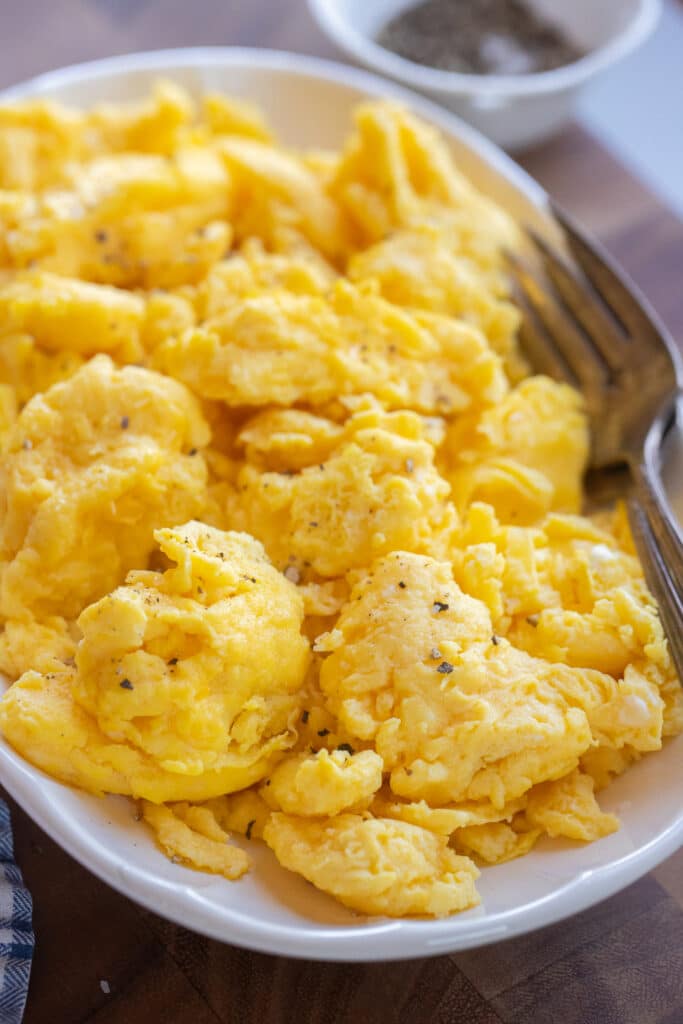 Close up of fluffy scrambled eggs on a serving platter