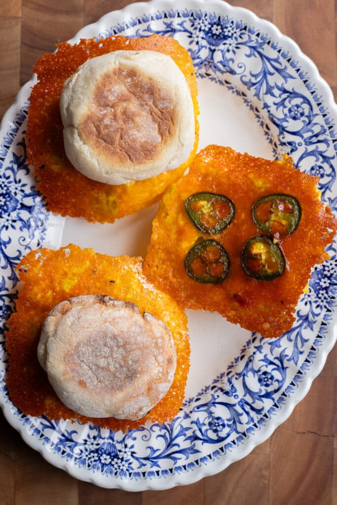 serving platter with three crispy cheese and egg breakfast sandwiches on it