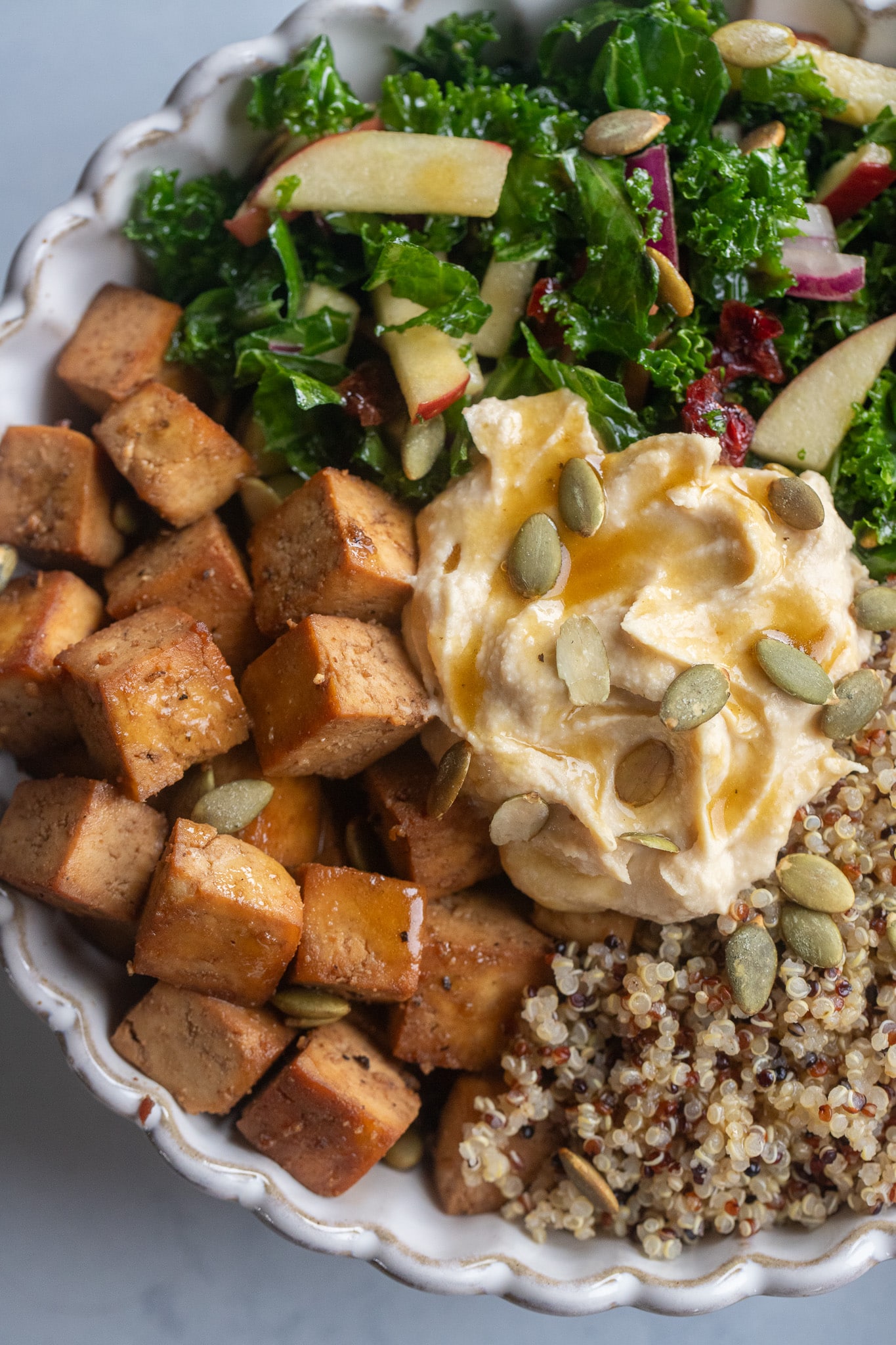 Close up of a balsamic tofu quinoa bowl with hummus