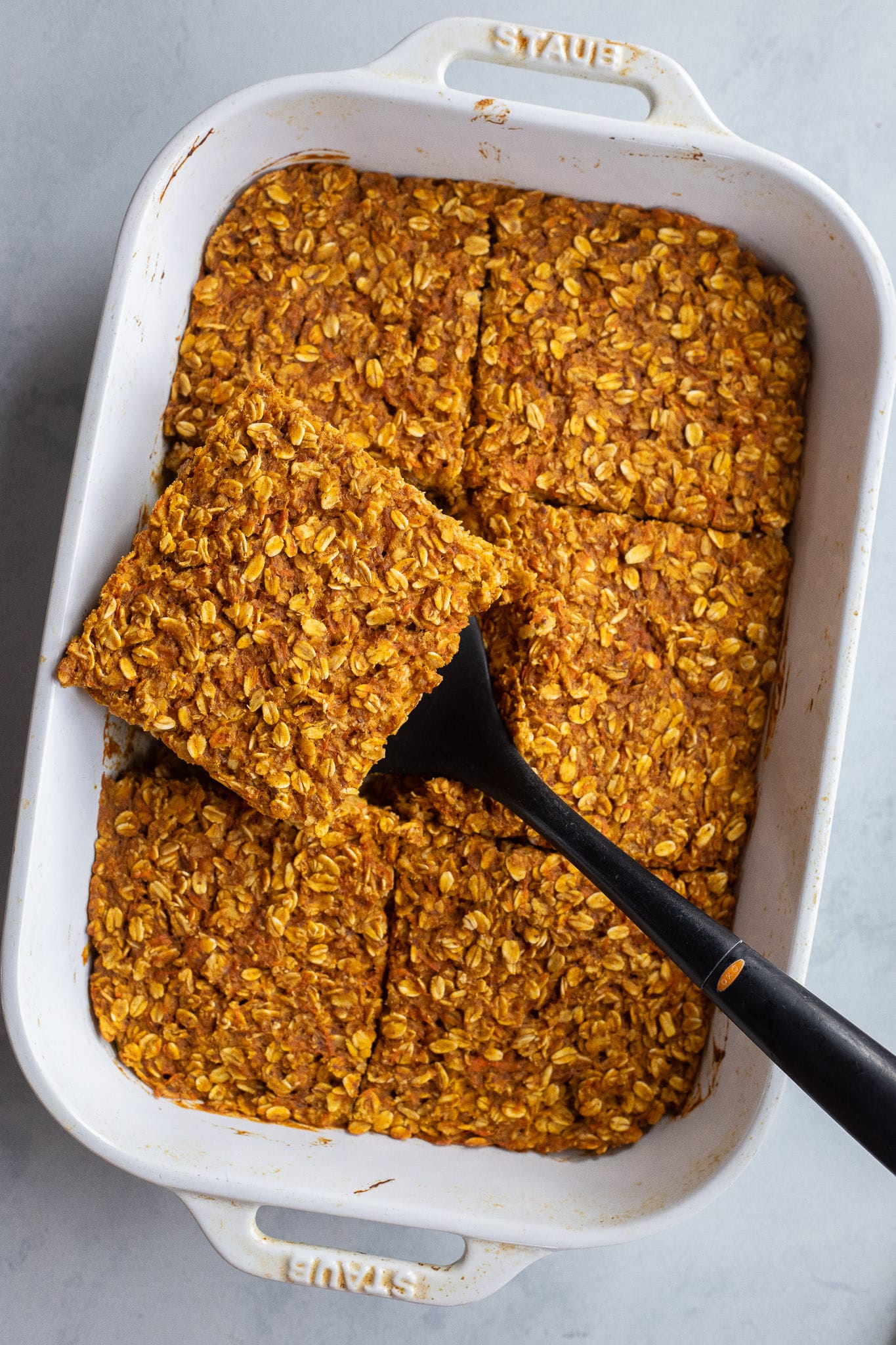 slice of pumpkin carrot baked oatmeal in a pan
